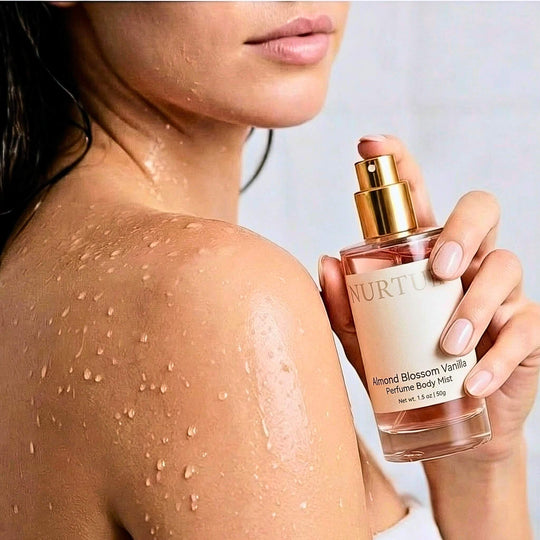 Person applying Nurture Almond Blossom Vanilla perfume body mist to their shoulder.