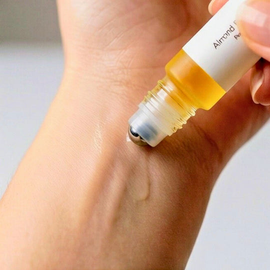 Almond Blossom rollerball being applied to a person&