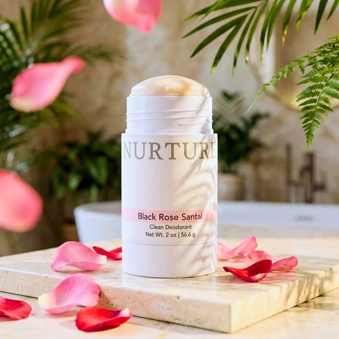  Black Rose Santal deodorant stick on a wooden board with flowers and plants in the background
