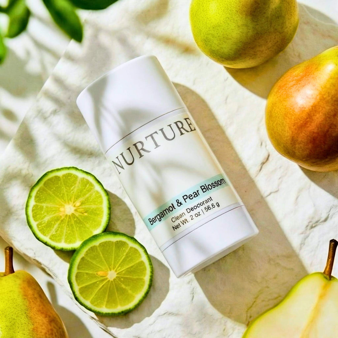Bergamot &amp; Pear Blossom deodorant with pears and limes on a light background