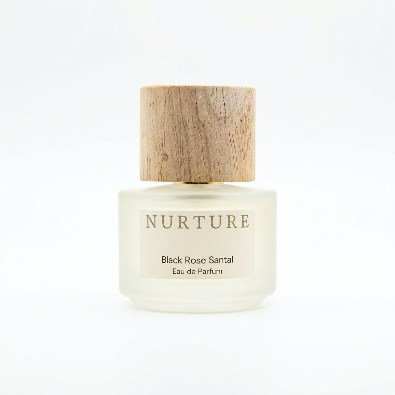 Perfume bottle labeled 'Nurture Black Rose Santal' with a wooden cap on a white background