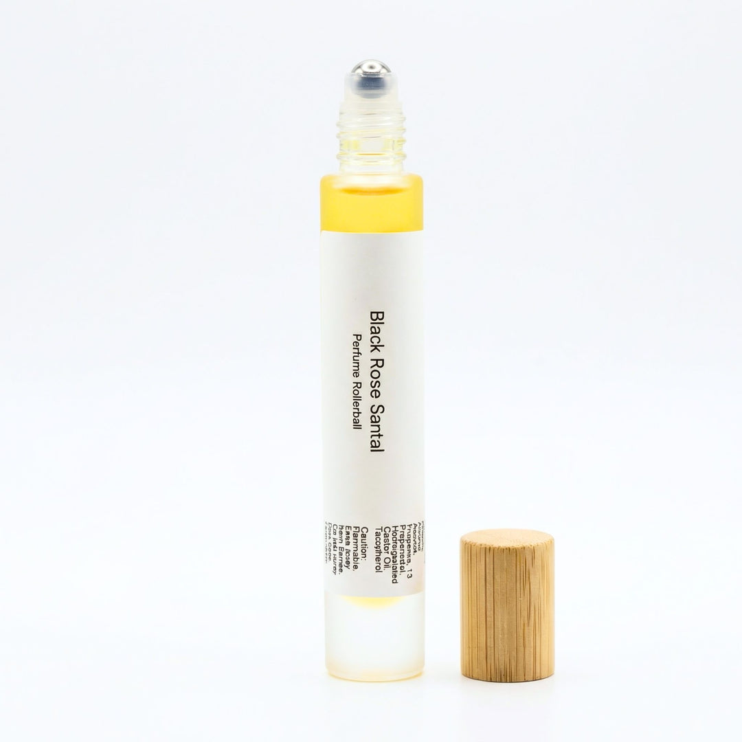 Black Rose Santal perfume rollerball on white background.