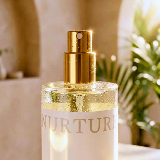 Close-up of Nurture Perfume body mist in a marble bathroom.