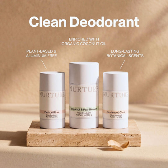 Three NURTURE clean deodorant sticks on a wooden block with a beige background