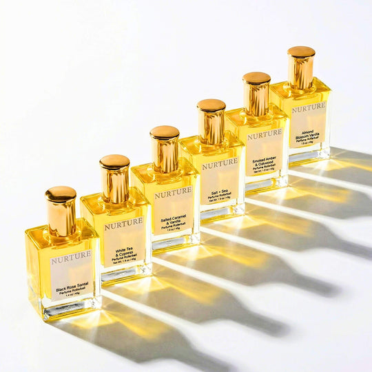 Set of Nurture rollerball perfume bottles with gold caps on a white background