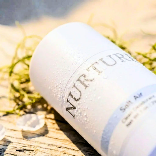 Salt Air deodorant bottle on a wooden surface with grass in the background
