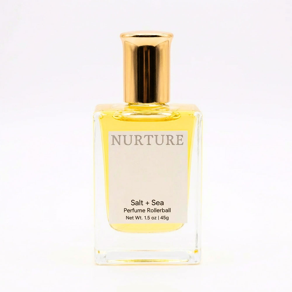 Perfume rollerball labeled 'Nurture Salt + Sea' on a white background