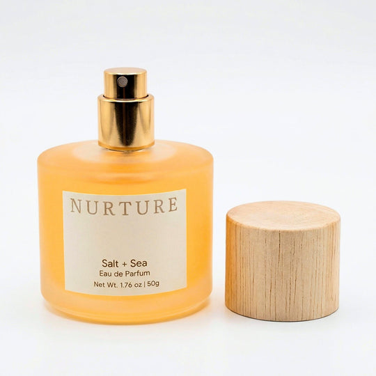 Salt + Sea perfume bottle and wooden cap on a white background