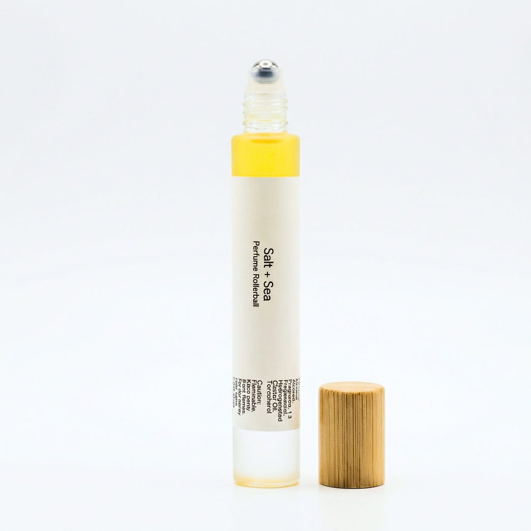 Salt + Sea perfume rollerball with wooden cap on a white background