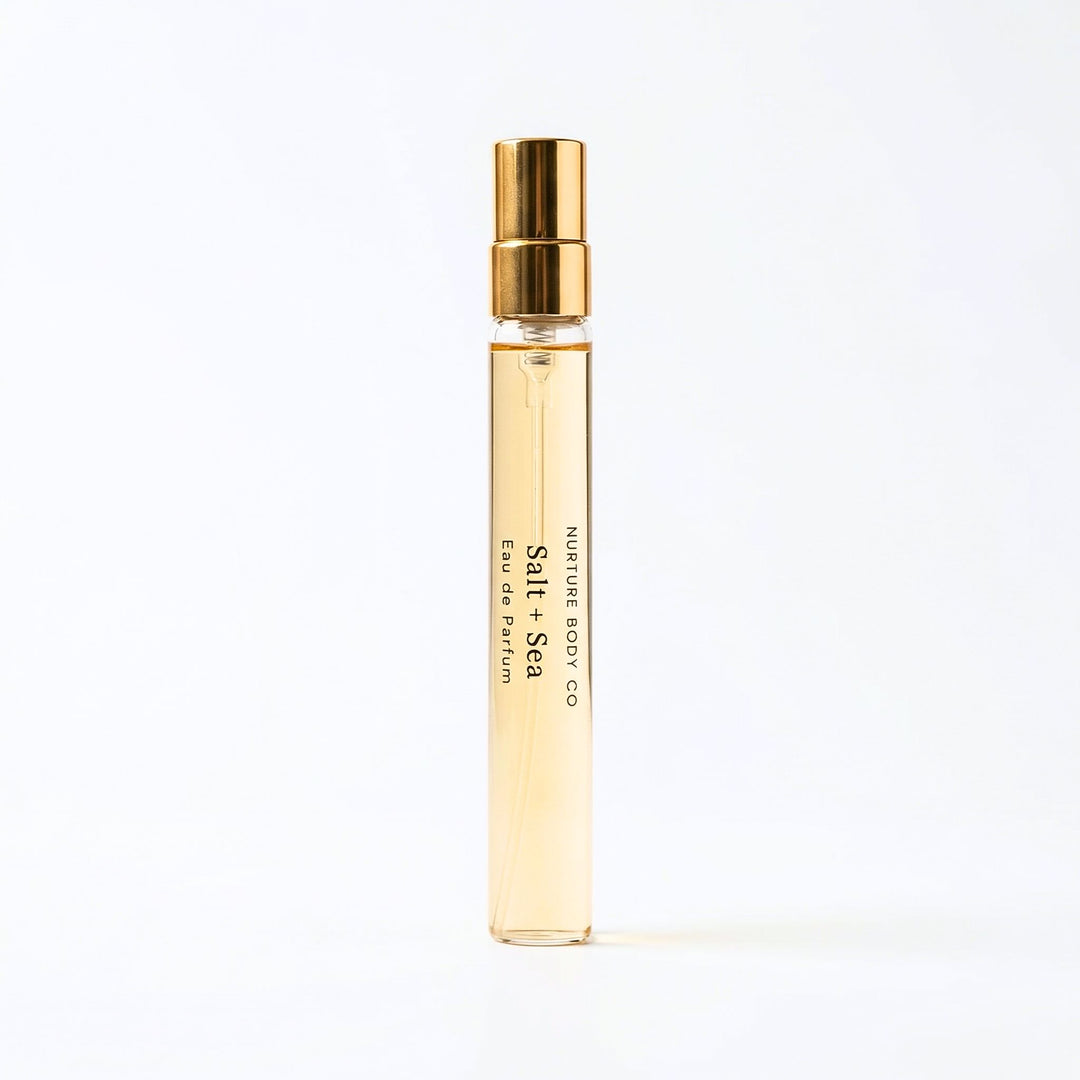 Perfume bottle with gold cap and visible branding on a white background