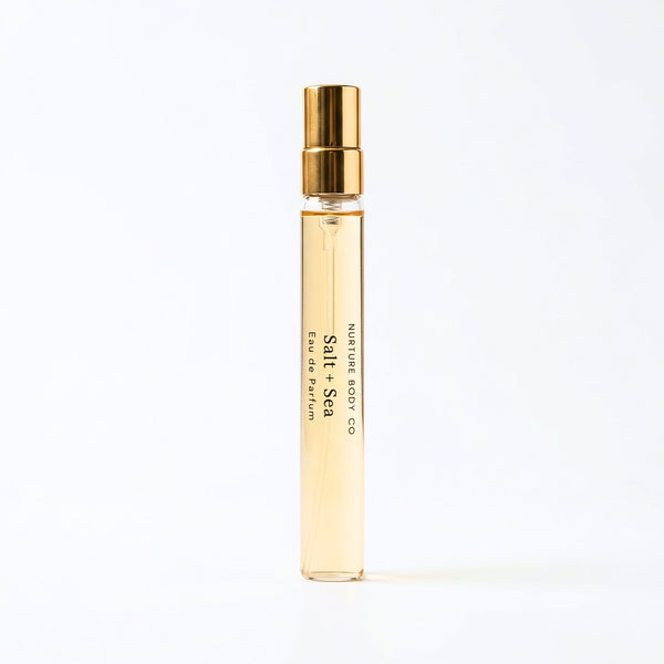Perfume bottle with gold cap and visible branding on a white background