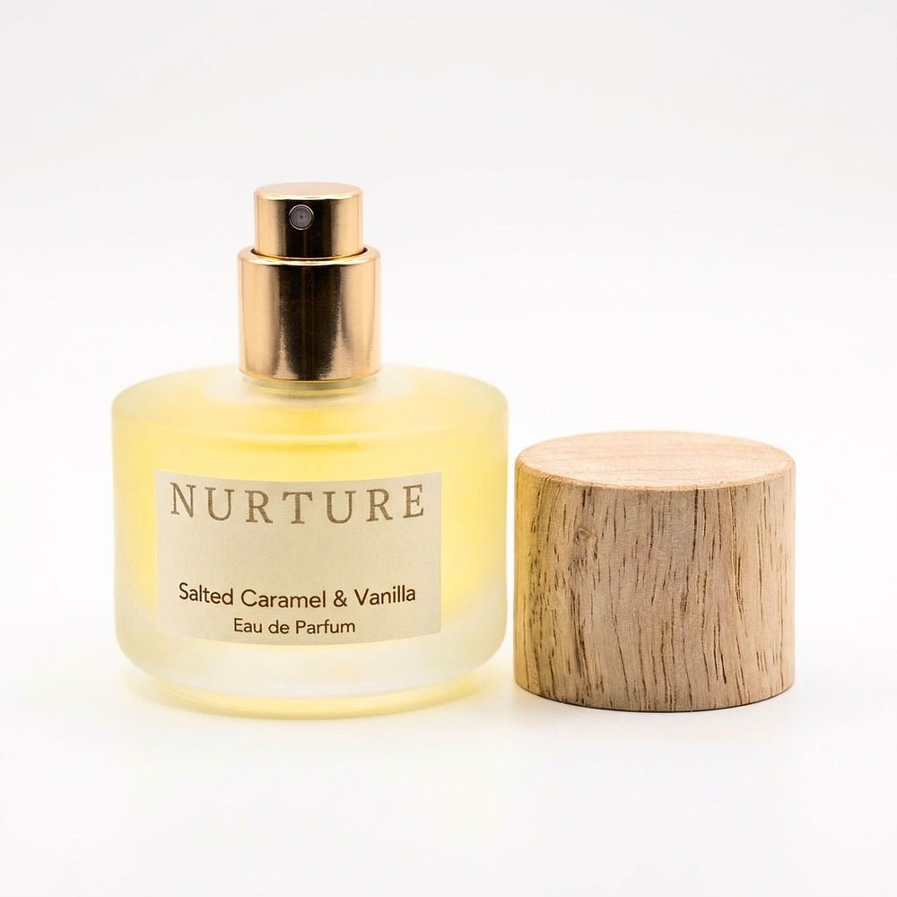 Perfume bottle labeled 'Nurture Salted Caramel & Vanilla' with wooden cap on a white background