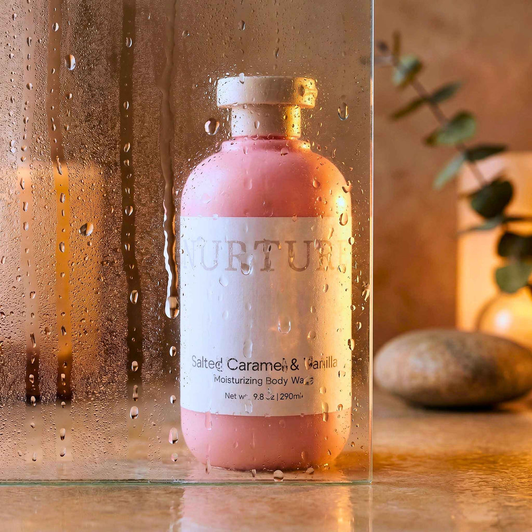 Salted Caramel body wash on a stone shower floor.