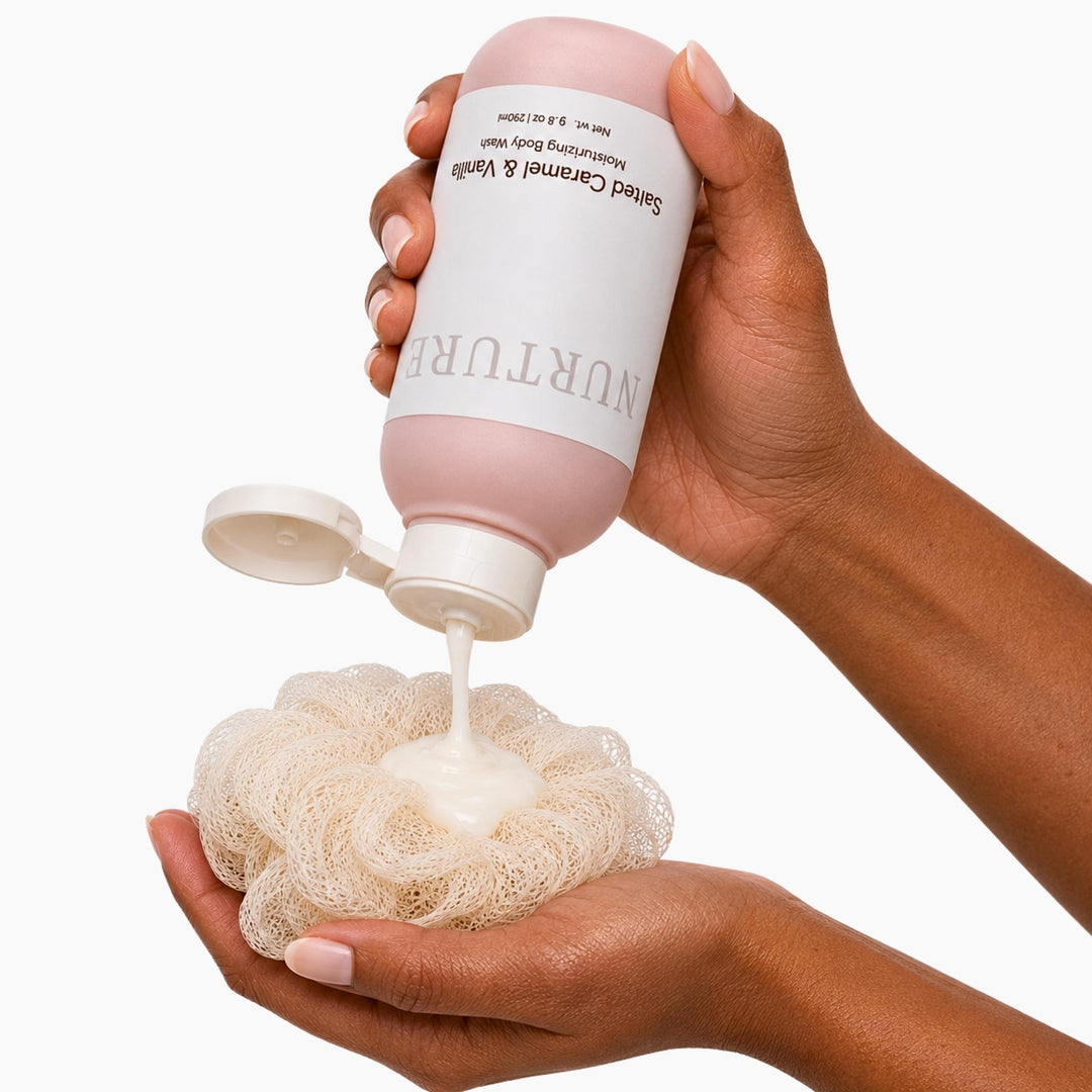 Body wash being squeezed onto a shower sponge.
