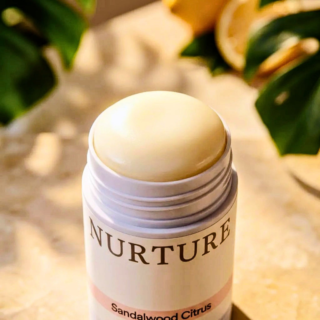 Sandalwood Citrus deodorant with the cap off against a neutral background.
