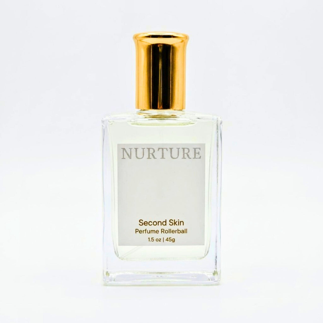 Perfume rollerball labeled 'Nurture Second Skin' with gold cap on a white background