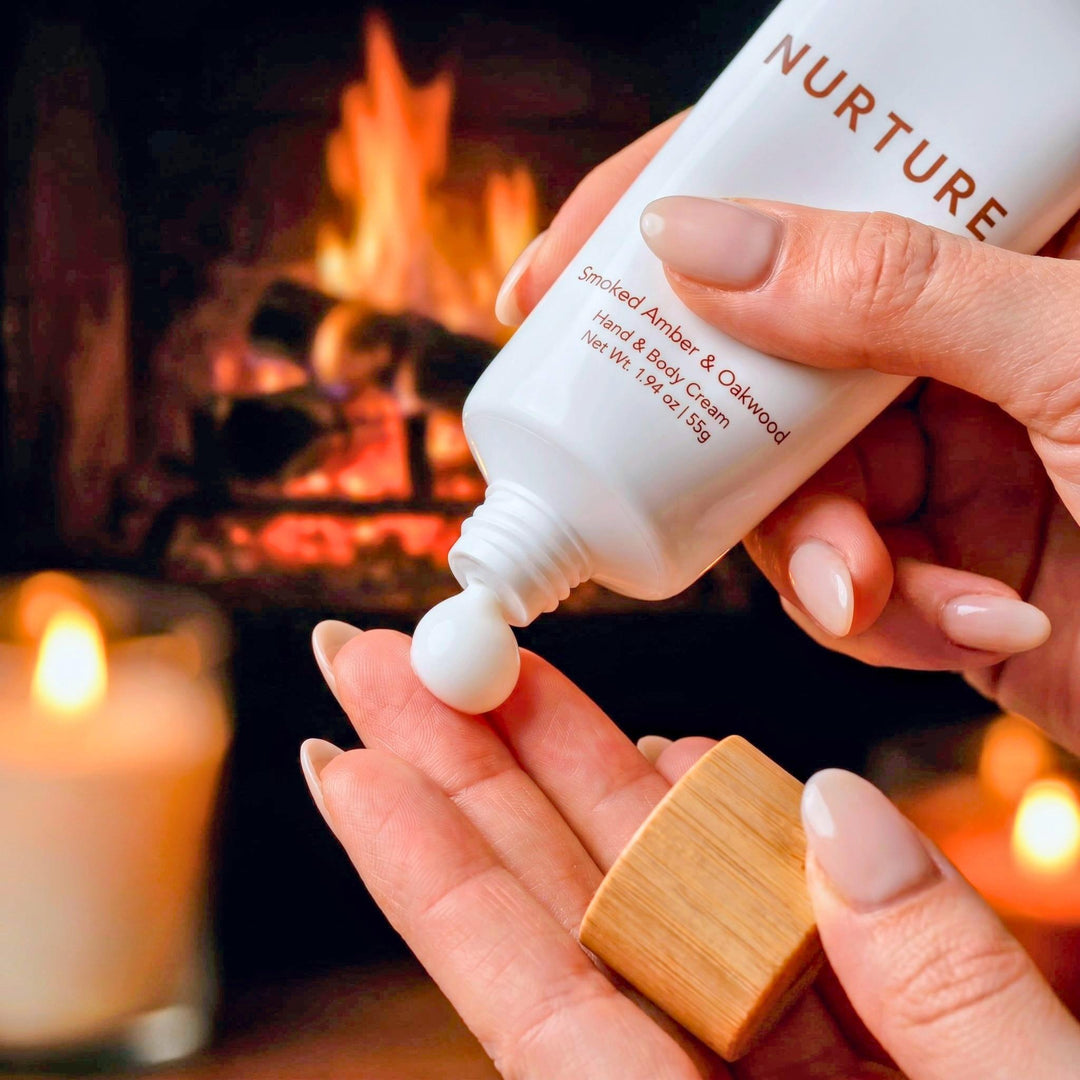 Hand applying cream from a bottle labeled &
