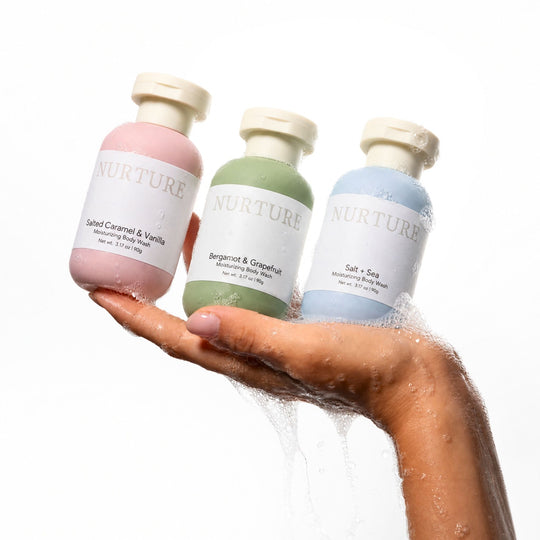 3 small bottles of body wash in a woman&