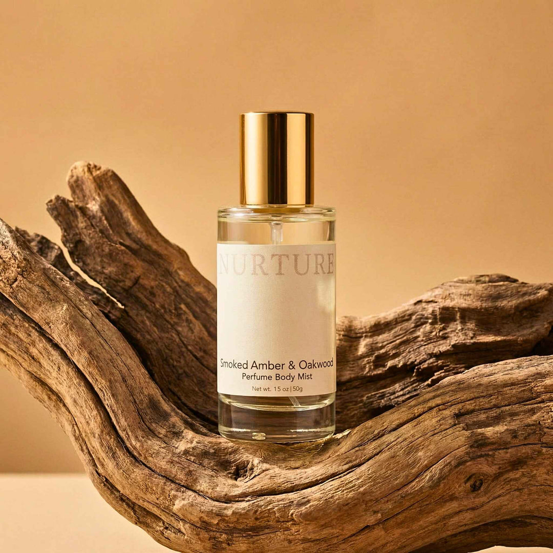 Smoked Amber &amp; Oakwood Perfume Body Mist on a wooden surface with a warm beige background