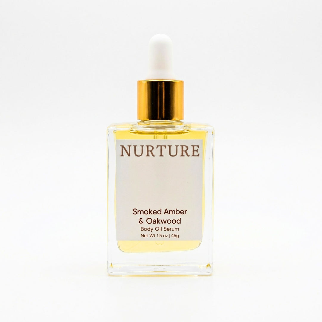 Smoked Amber & Oakwood body oil serum bottle with gold cap on a white background