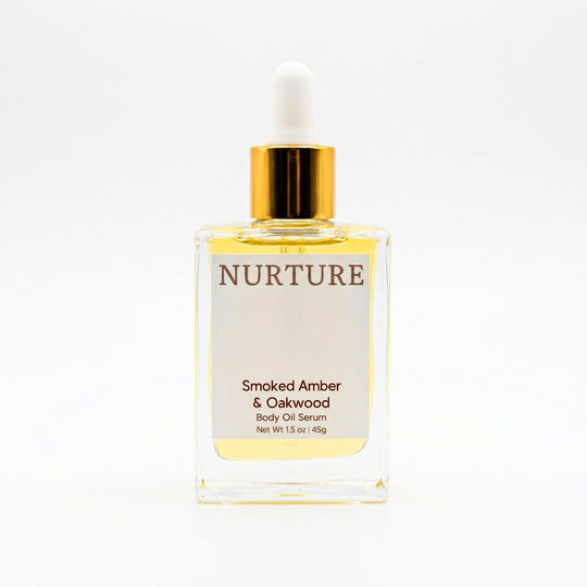 Smoked Amber &amp; Oakwood body oil serum bottle with gold cap on a white background