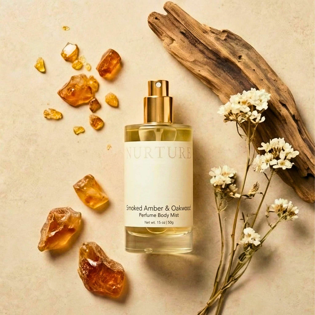 Smoked Amber &amp; Oakwood Body Mist with amber stones and flowers on a beige background