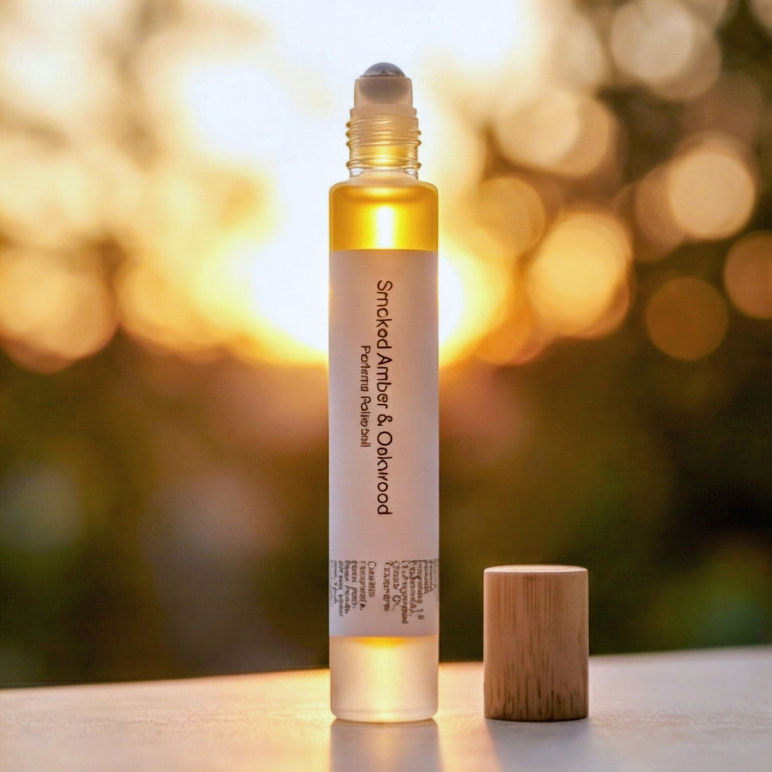 Smoked  Amber &amp; Oakwood rollerball on a neutral surface with a blurred background.