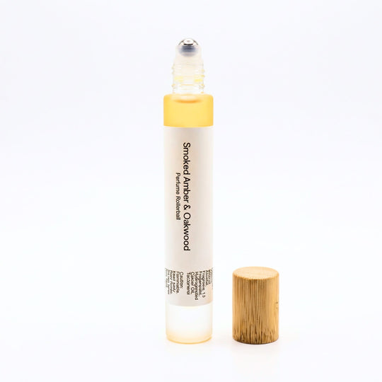 Smoked Amber Oakwood perfume rollerball on a white background.