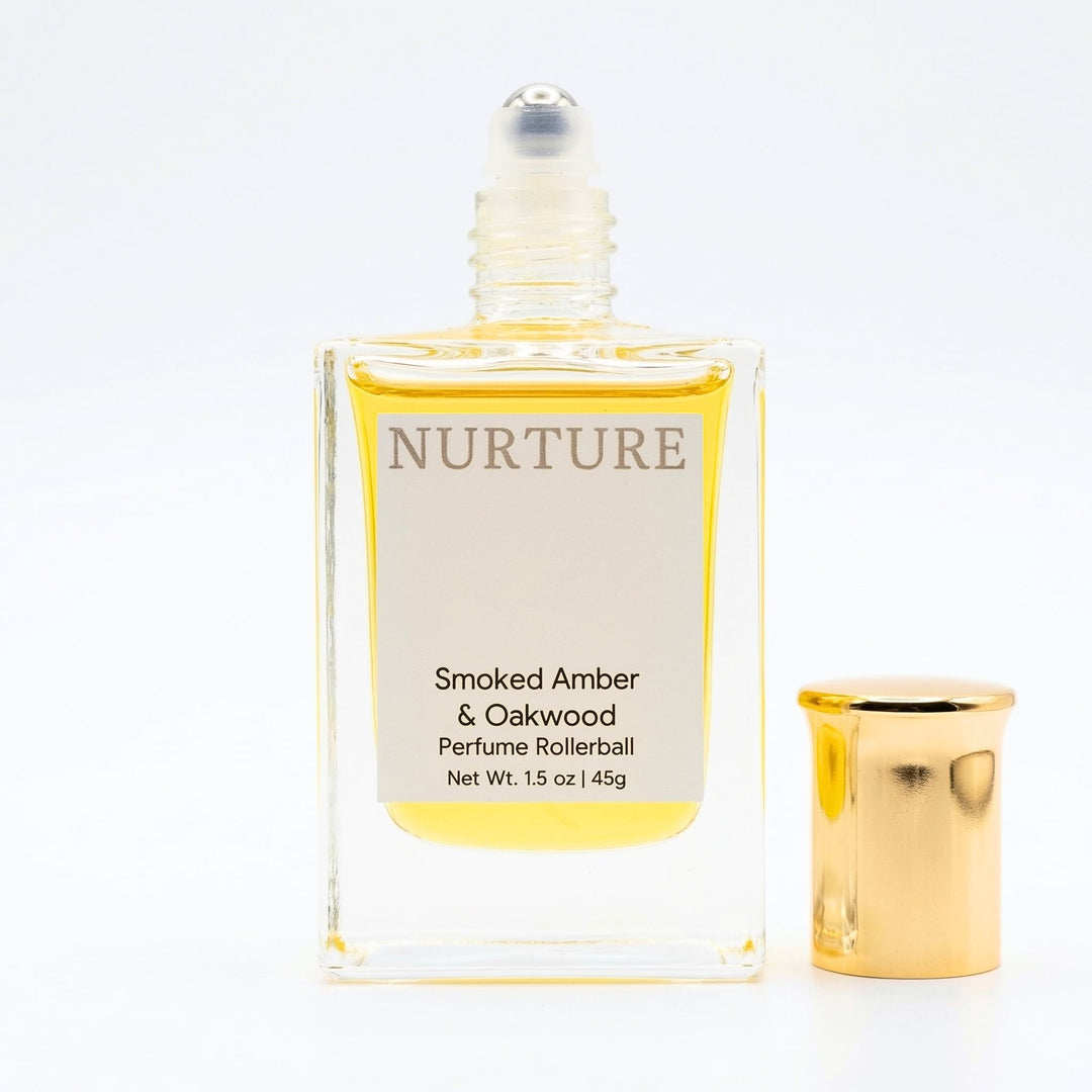Smoked Amber Perfume rollerball labeled with gold cap on a white background