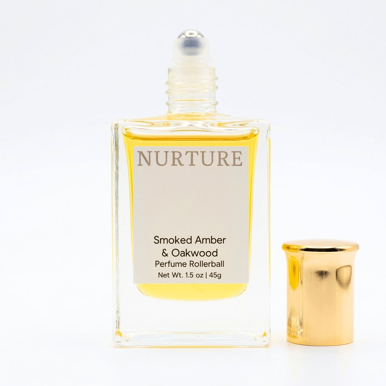 Smoked Amber Perfume rollerball labeled with gold cap on a white background