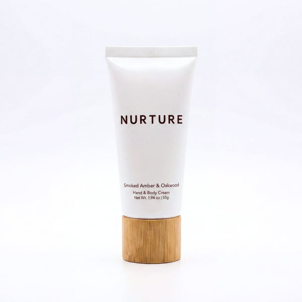 Tube of 'Nurture' hand and body cream with a wooden cap on a white background