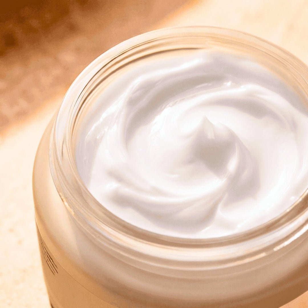 Jar of white cream with a close-up view on a wooden surface