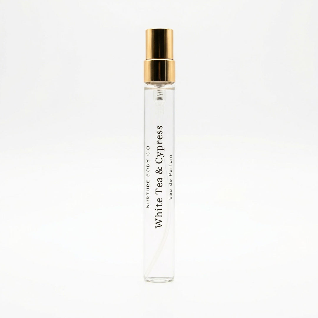 Perfume bottle labeled 'White Tea & Cypress' by Nurture Body Co on a white background