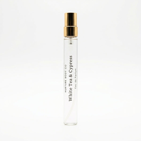 Perfume bottle labeled 'White Tea & Cypress' by Nurture Body Co on a white background
