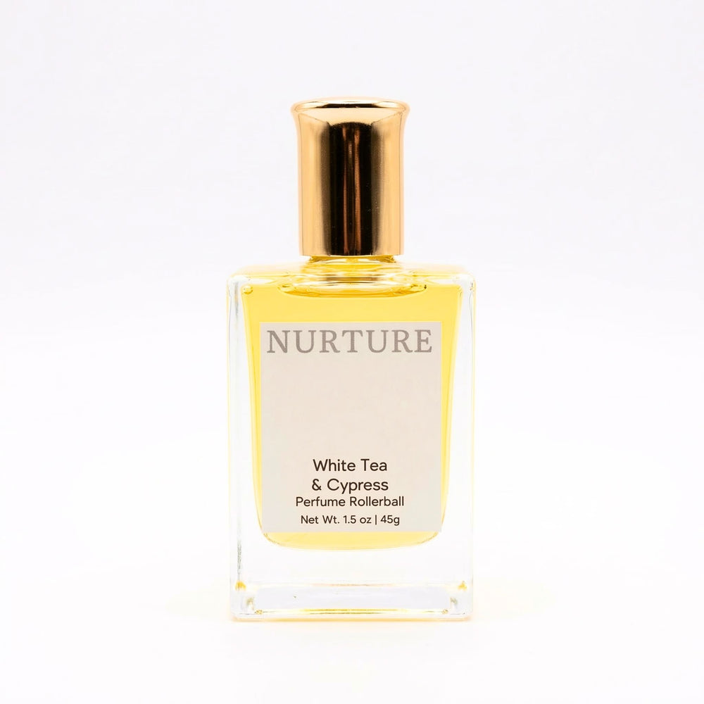 Perfume rollerball labeled 'Nurture White Tea & Cypress' on a white background