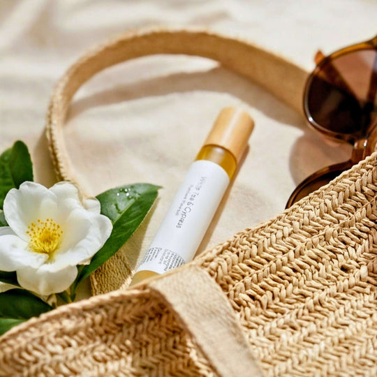 White Tea &amp; Cypress rollerball in a beach bag with sunglasses.
