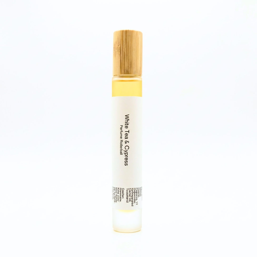 White Tea perfume rollerball with wooden cap on a white background
