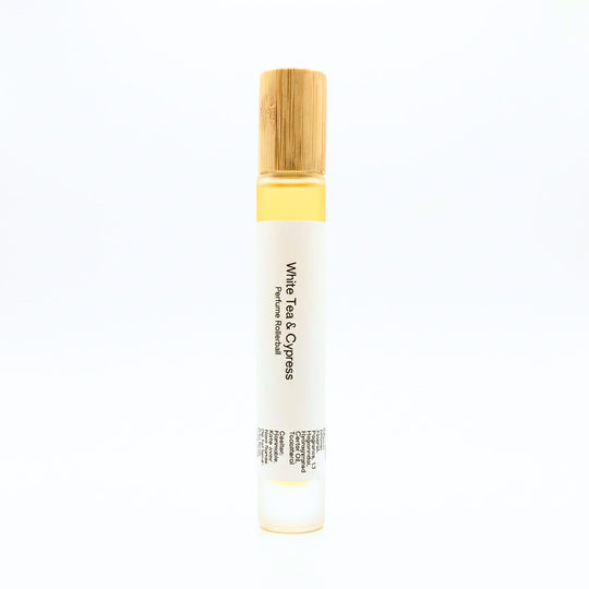 White Tea perfume rollerball with wooden cap on a white background