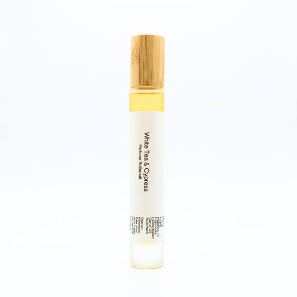 White Tea perfume rollerball with wooden cap on a white background