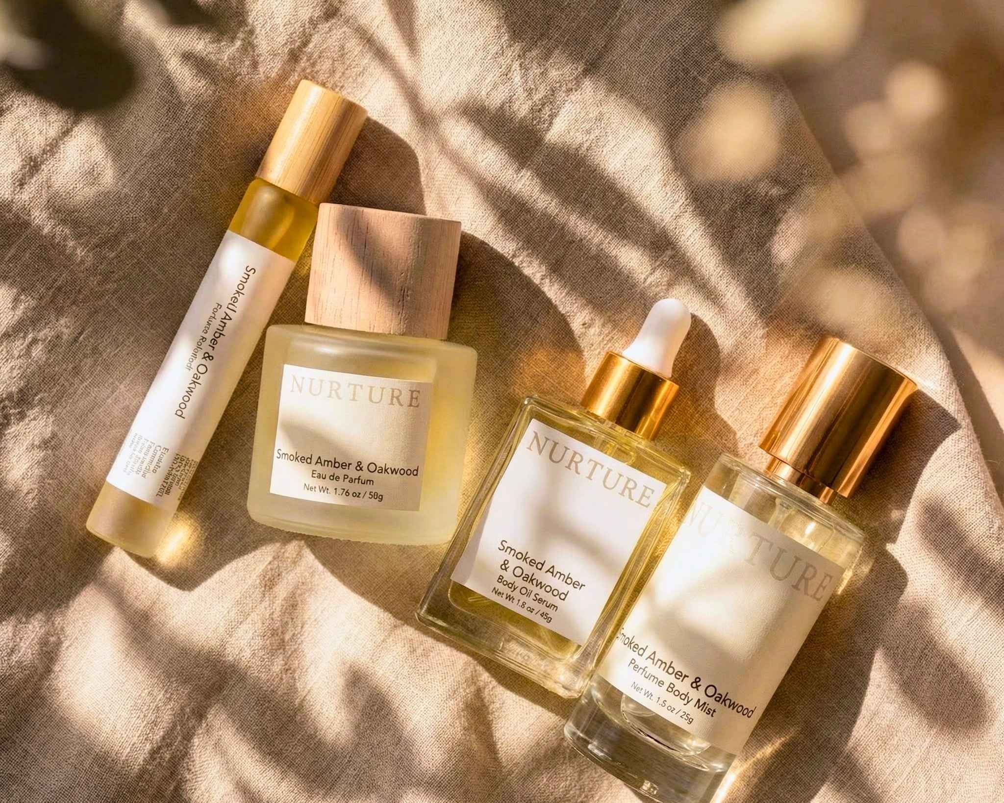 Four bottles of 'Nurture' products on a textured surface with sunlight casting shadows.