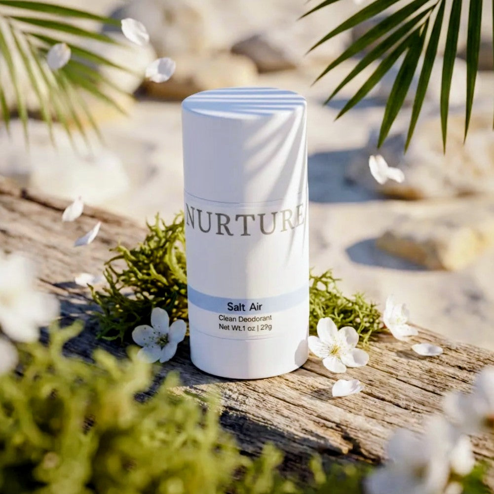 Salt Air deodorant stick on a natural background with flowers and leaves.